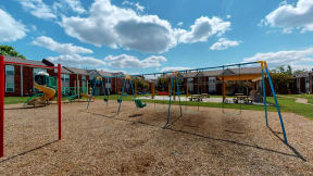 a playground with a swing set and other playground equipment