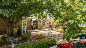 a house with a driveway and a tree in front of it