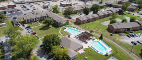 an aerial view of a pool and houses in a neighborhood
