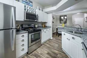 a kitchen with stainless steel appliances and white cabinets