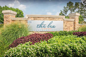 a sign that reads the lee in front of a stone wall