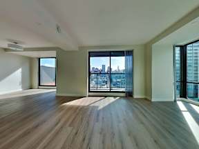 an empty living room with wood flooring and a balcony at 1700 California Street, San Francisco, CA, 94109