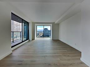 a living room with a large window and a wooden floor at 1700 California Street, San Francisco, 94109