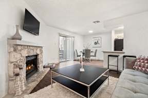 A black coffee table in the middle of a living room.