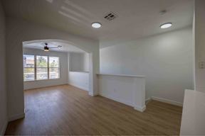 A room with a fan and a window.