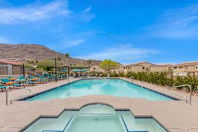 A large outdoor swimming pool with a mountain in the background.