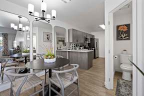 A modern kitchen with a dining table and chairs.