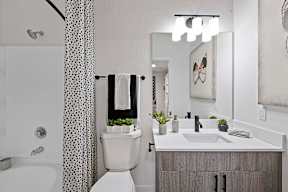 A white toilet sits next to a sink in a bathroom.