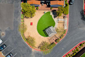 A park area with a green hill and a playground.