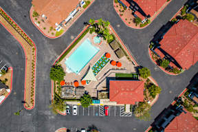 A view of a roundabout with a pool and a building in the middle.