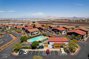 A large building complex with a pool in the middle.