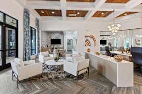 A modern living room with a white sofa set and a wooden coffee table.