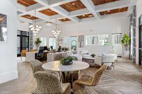 A large room with a round table and chairs.