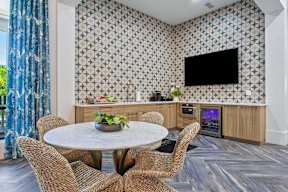 A modern dining room with a round table and chairs.