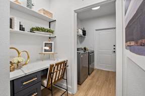 A kitchen with a white countertop and a wooden chair.
