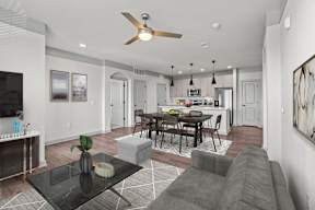 A modern living room with a black coffee table and grey sofa.