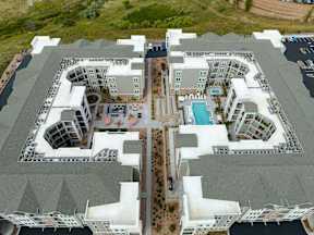 A large white building with a pool in the middle.