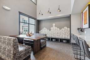 A modern dining room with a wooden table and chairs.