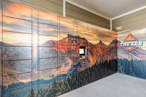 A wall mural of a mountain landscape with a cabin and the text