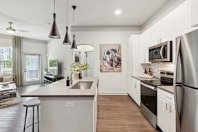 A modern kitchen with a large island and stainless steel appliances.