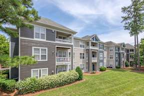 Apartment complex with multiple buildings and green lawns.