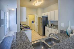A kitchen with granite countertops and stainless steel appliances.
