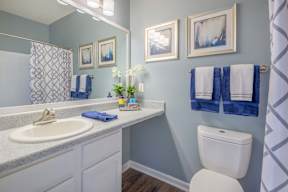 A bathroom with a white toilet and a white sink.