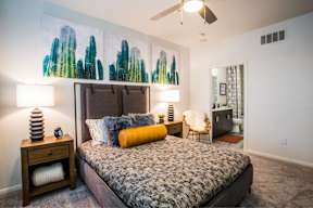 a bedroom with a bed and a ceiling fan