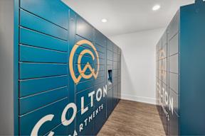 a hallway with blue lockers and a logo on the wall
