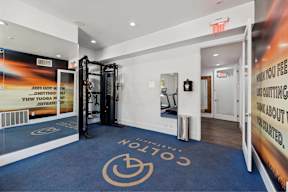 a gym with a blue carpet with the logo of the volitions