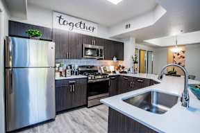 a modern kitchen with stainless steel appliances and a sink