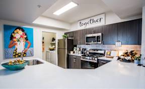 a kitchen with stainless steel appliances and a white counter top
