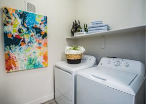 private laundry room with washer and dryer and art on the wall