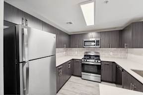 a kitchen with stainless steel appliances and wooden cabinets