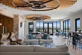 A modern living room with a large window overlooking the ocean.