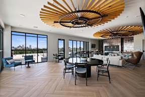 A modern living room with a large wooden chandelier.