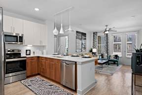 A modern kitchen with wooden cabinets and stainless steel appliances.