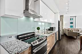 A modern kitchen with a black and white granite countertop.