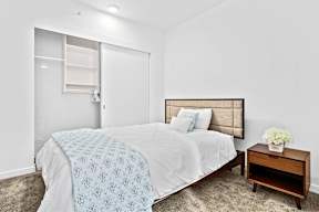 Large bed with nightstand at Soma Towers apartments for rent in Bellevue, WA