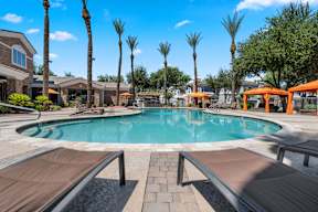 Pool surrounded by palm trees at Artessa apartments in North Glendale.