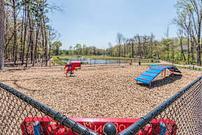 A playground with a red slide and a blue slide.