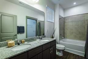 A bathroom with a sink, toilet, and bathtub.