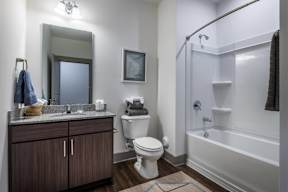 A bathroom with a toilet, sink, and bathtub.