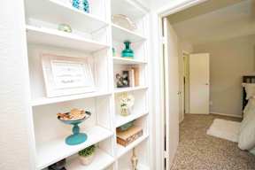 A white shelf with various objects on it.