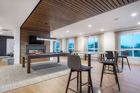 A modern dining room with a wooden table and chairs.