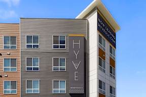 A modern apartment building with a sign that reads "Hyve".