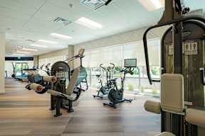 A gym with exercise equipment and a window.
