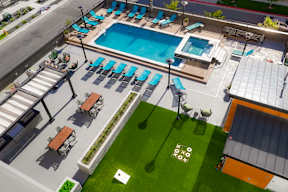 A pool area with a small building to the right.