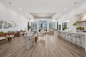 A spacious living room with wooden floors and furniture.