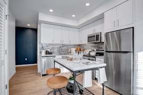 A modern kitchen with a table and chairs.